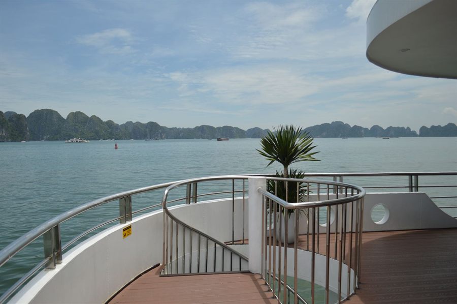 Outer deck of a small ship looking out over islands in a misty bay