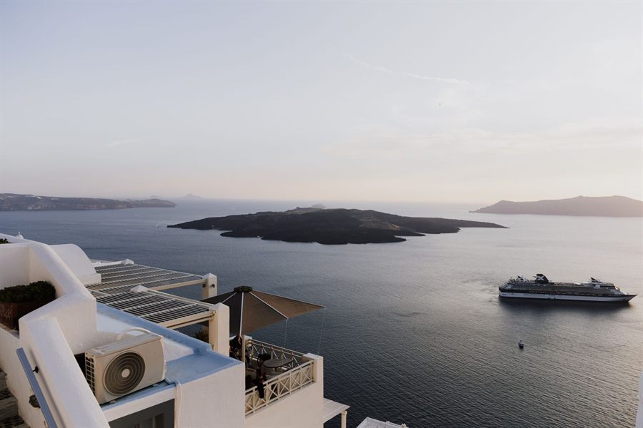 View from a terrace over the Santorini caldera with a cruise ship at anchor