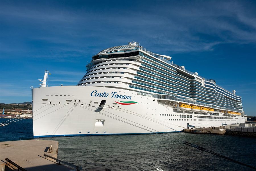 Costa Toscana, a large resort-style cruise ship, docked under a blue sky