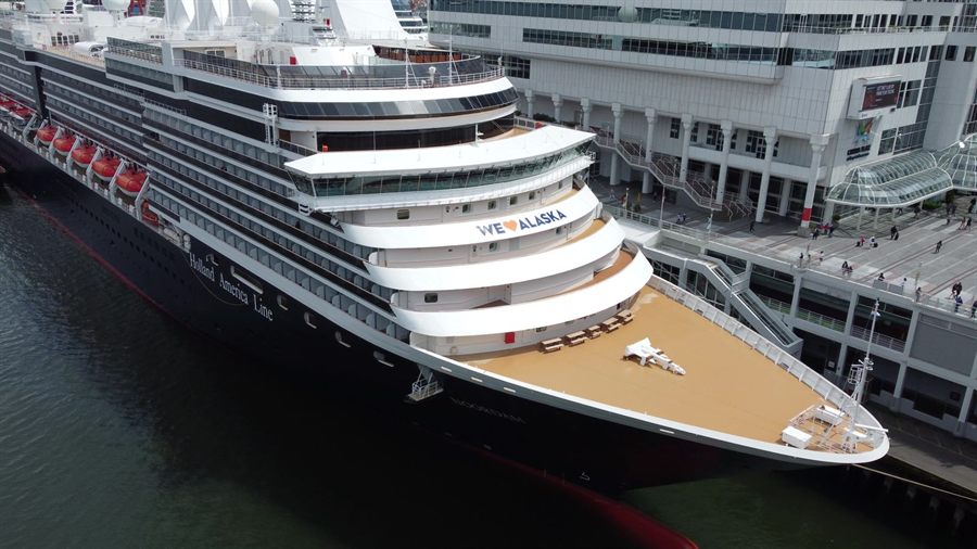 Holland America Line ship docked at a cruise terminal, seen from above